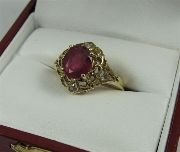 Appraisal: RUBY DIAMOND AND K GOLD RING centering an oval-cut ruby