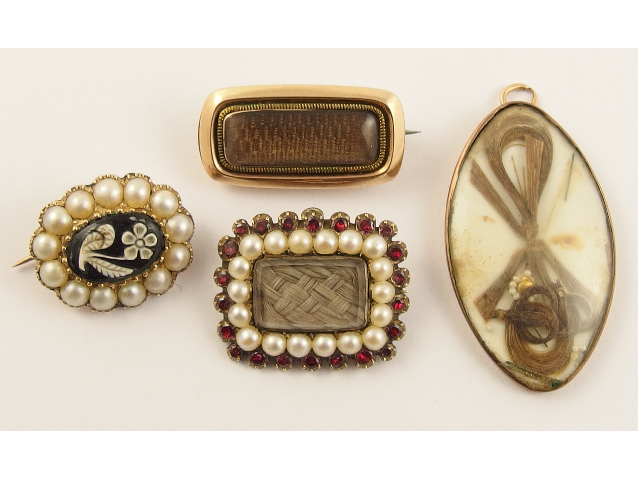 Appraisal: A collection of four Georgian mourning pendants and brooches a