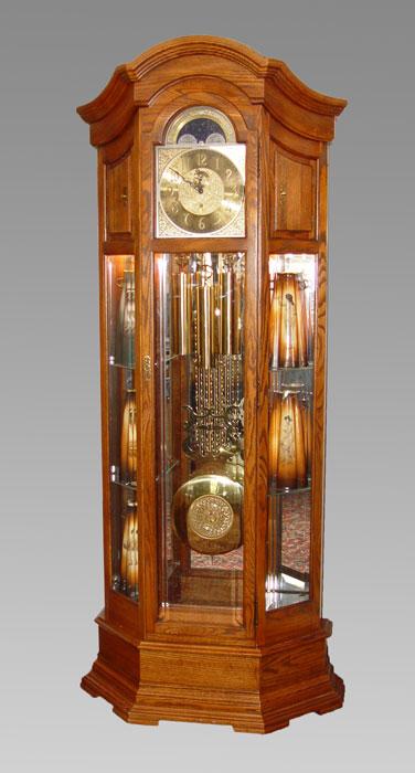 Appraisal: HOWARD MILLER MAJESTIC CURIO GRANDFATHER CLOCK Oak case Arched pediment