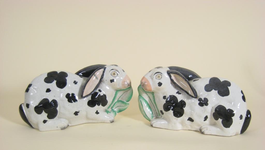 Appraisal: Pair of th Century Staffordshire pottery Rabbits eating green leaves