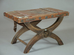 Appraisal: An X-frame leather stool th century the seat with leather