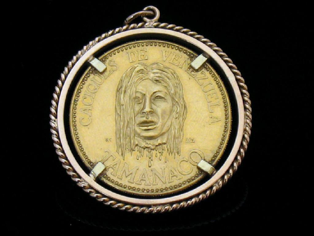 Appraisal: A VENEZUELAN TAMANACO COLLECTOR'S COIN mounted in a rope-twist pendant