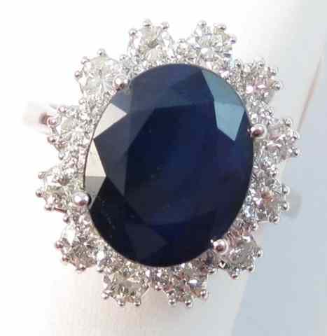 Appraisal: SAPPHIRE DIAMOND AND FOURTEEN KARAT GOLD RING centering an oval-cut