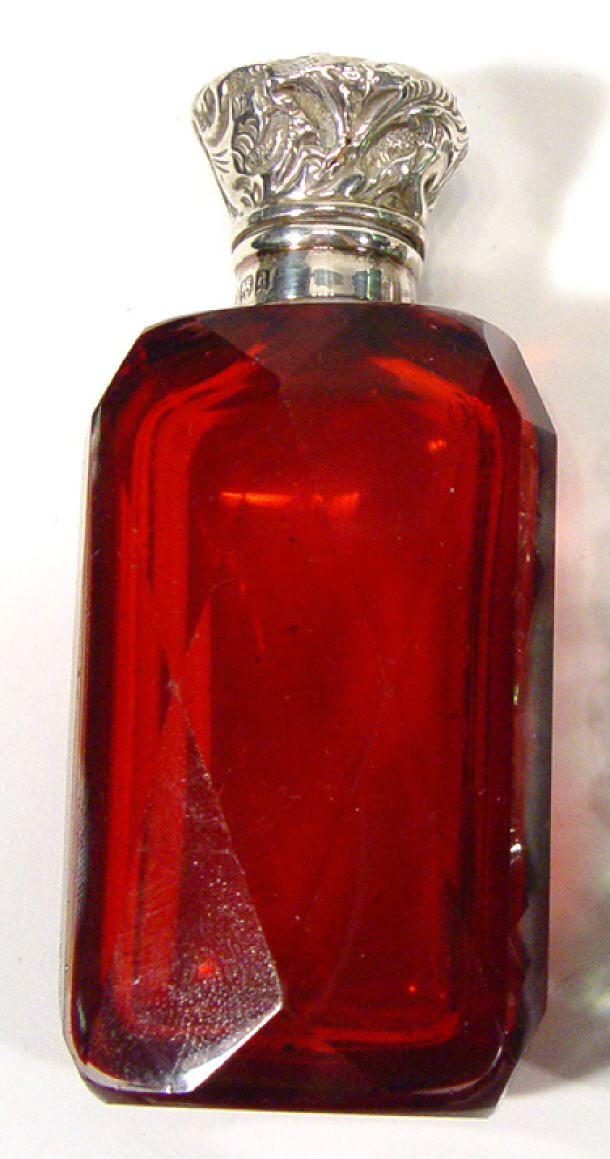 Appraisal: Cranberry cut glass scent bottle with embossed silver mount Birmingham