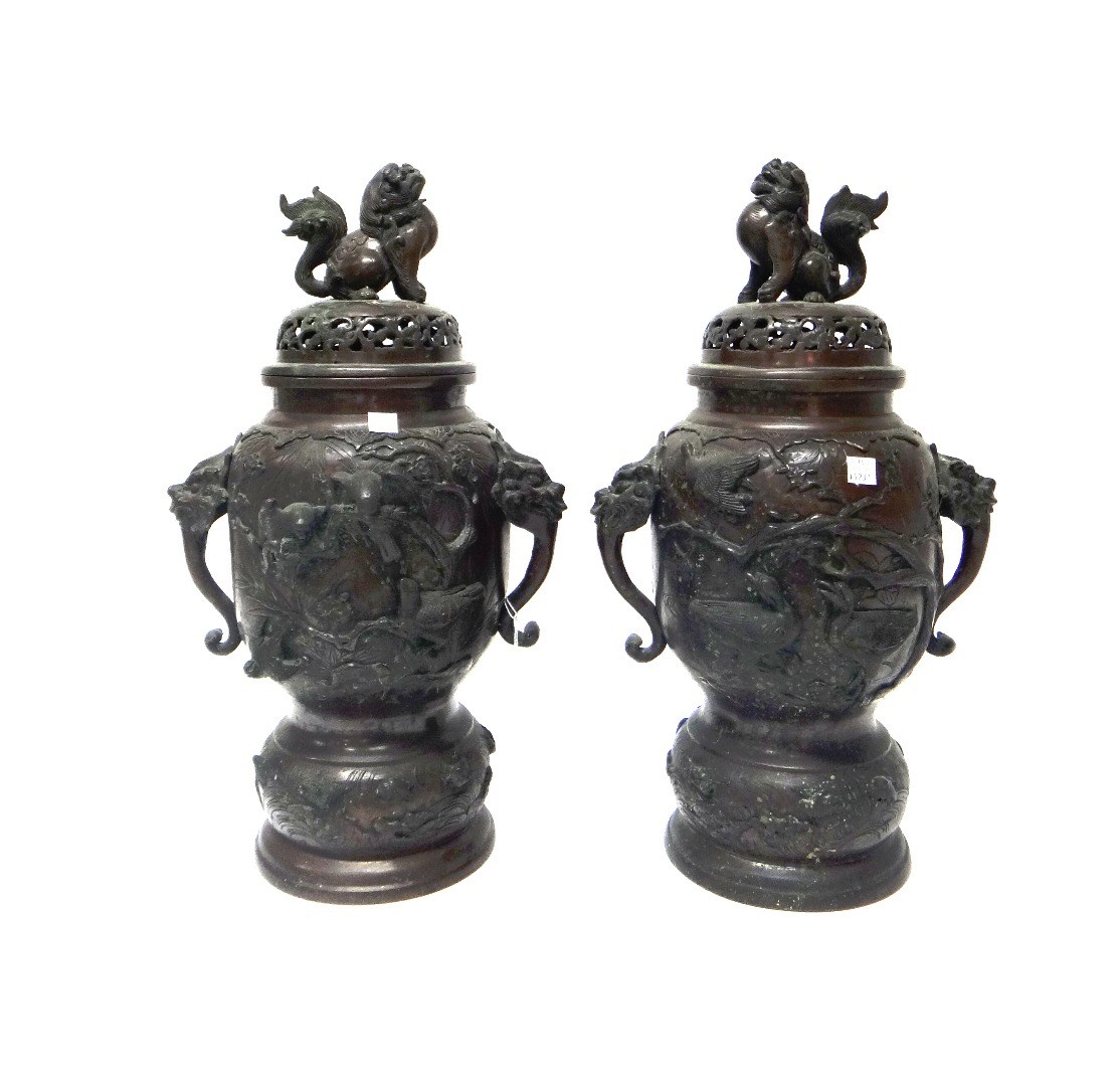 Appraisal: A pair of Japanese bronze vases and covers Meiji period