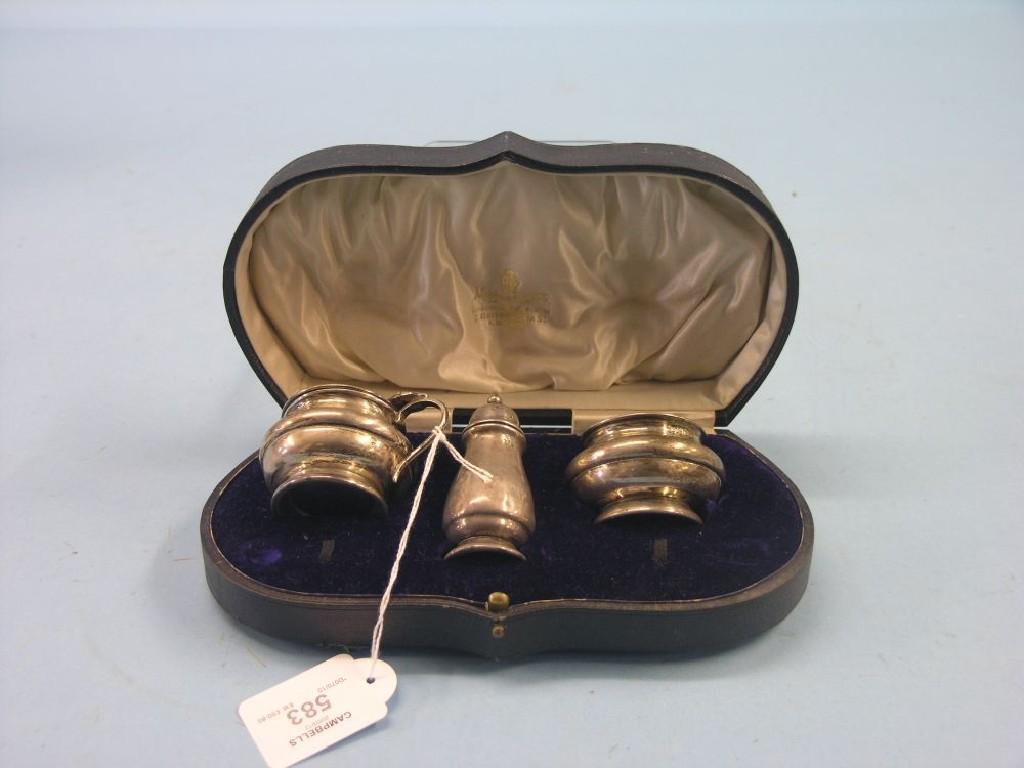 Appraisal: A cased silver condiment trio salt mustard and pepper Birmingham