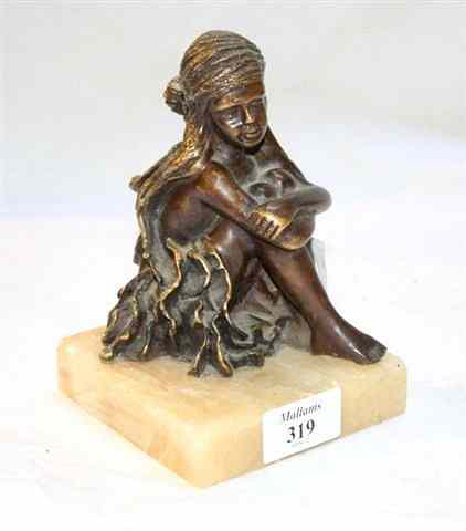 Appraisal: A BRONZE FIGURE of a seated girl with flowing head