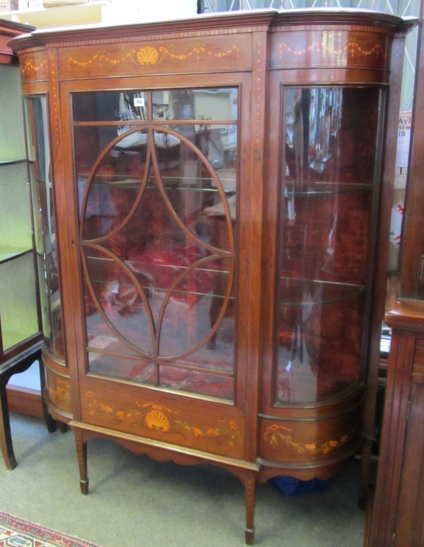 Appraisal: An Edwardian marquetry inlaid mahogany bowfront display cabinet with single