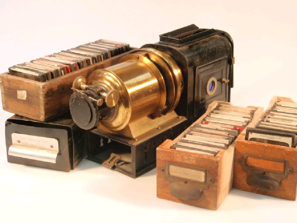 Appraisal: A brass and tin plate magic lantern projector and a