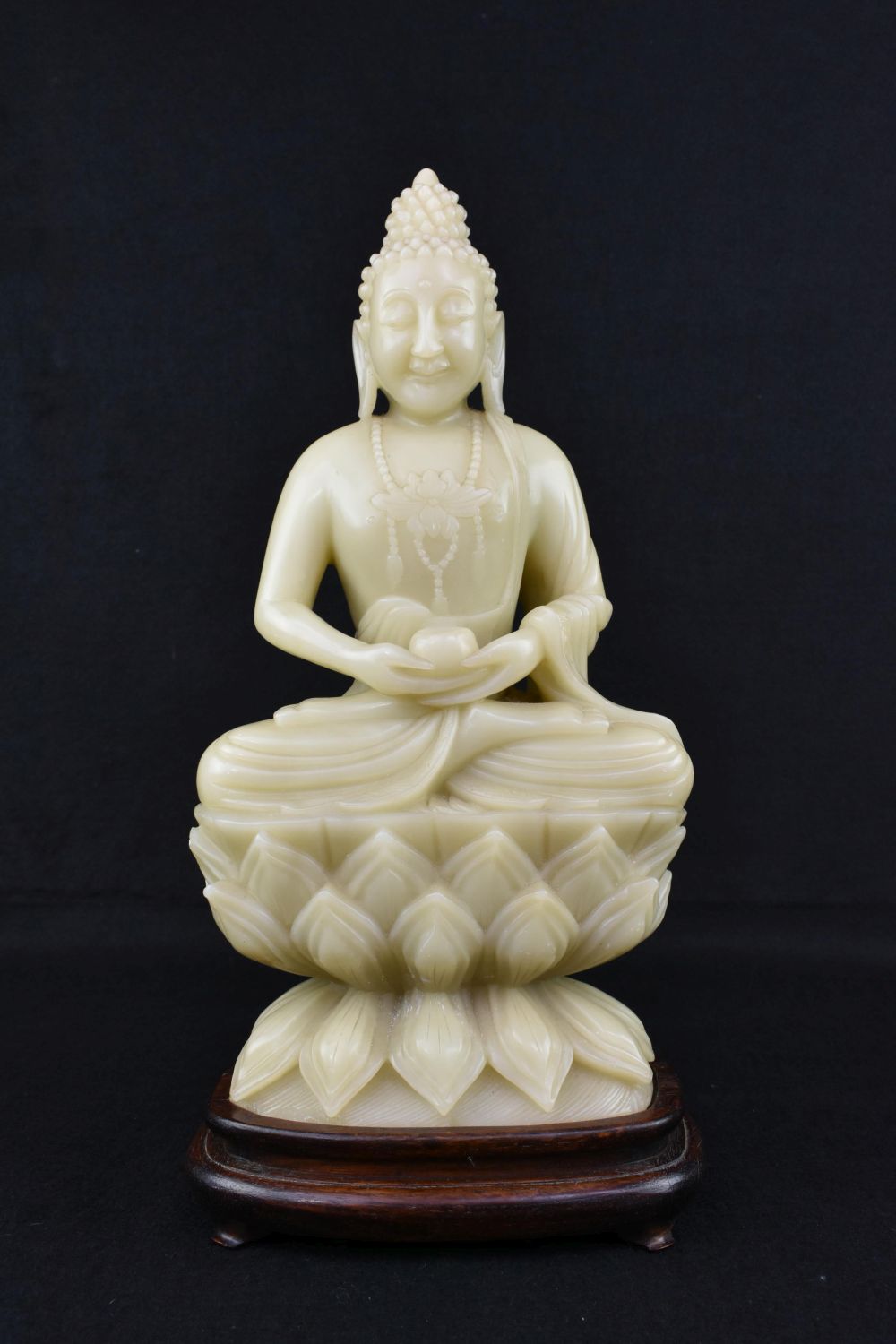 Appraisal: CHINESE CARVED SOAPSTONE SEATED BUDDHAThe celadon hued colored mineral with