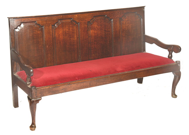 Appraisal: A GEORGE III OAK SETTLE with arched four panel back