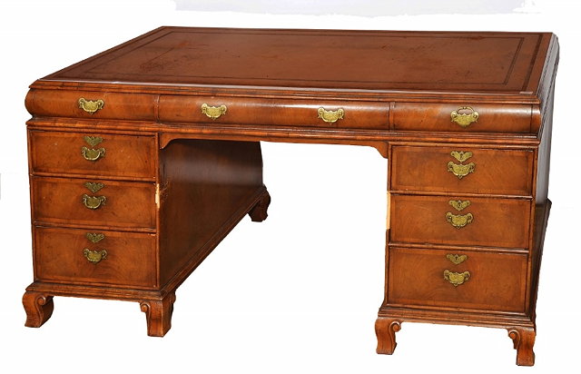 Appraisal: A WALNUT VENEERED PARTNERS DESK the rectangular top with inset