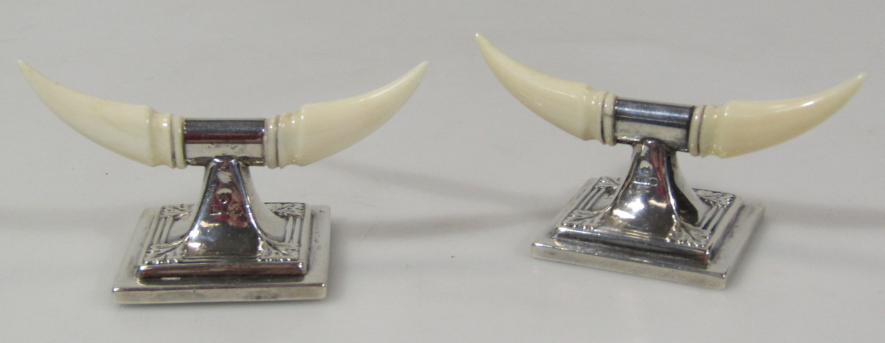 Appraisal: A near matching pair of silver knife rests each with