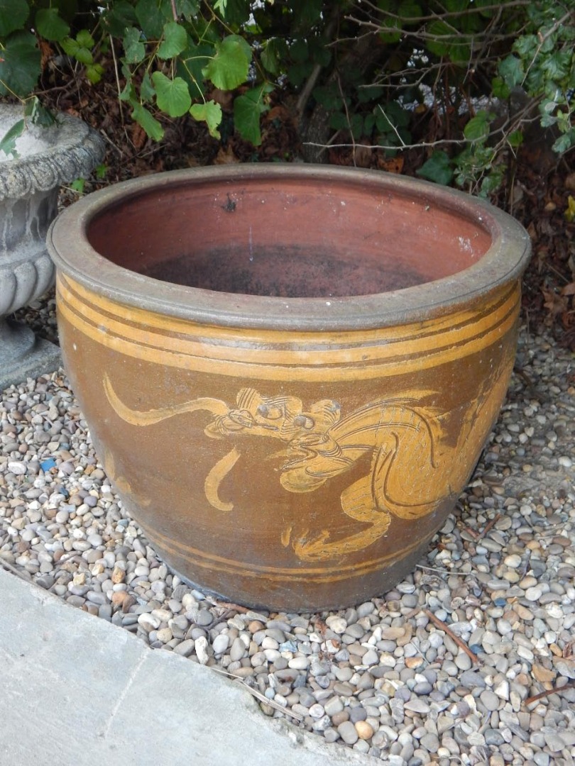 Appraisal: A Chinese stoneware jardiniere decorated in raised slip with dragons