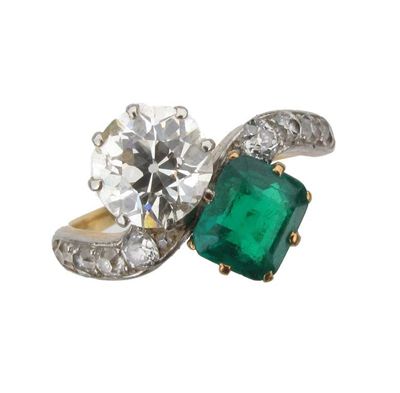 Appraisal: An emerald and diamond cross over ring Set with a