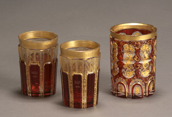 Appraisal: Three Bohemian Gilt Decorated Ruby Overlaid Cut Glass Beakers Late