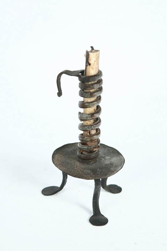 Appraisal: CANDLESTICK European th century wrought iron Spiral stick with tripod