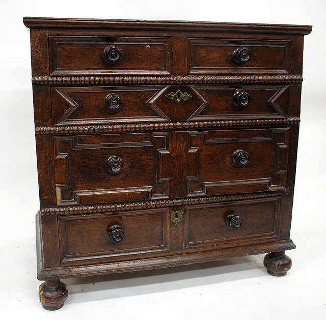 Appraisal: AN OLD OAK CHEST OF TWO SHORT AND THREE LONG