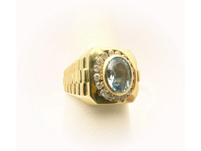 Appraisal: K yellow gold ring with large oval faceted aquamarine surrounded