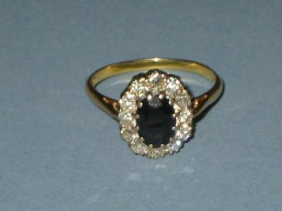 Appraisal: A SAPPHIRE AND DIAMOND CLUSTER RING of oval form the