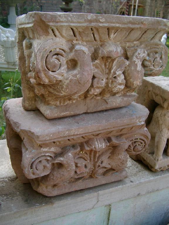 Appraisal: Pair of carved red sandstone Capitals with scroll design in