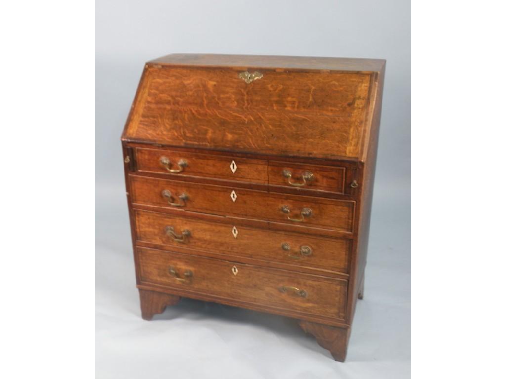 Appraisal: An early thC oak and mahogany cross banded bureau with