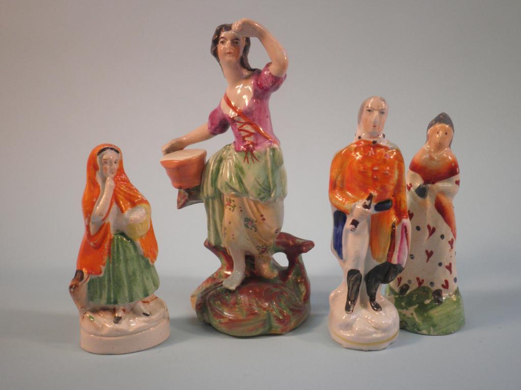 Appraisal: A thC Staffordshire figure of a lady with a bucket