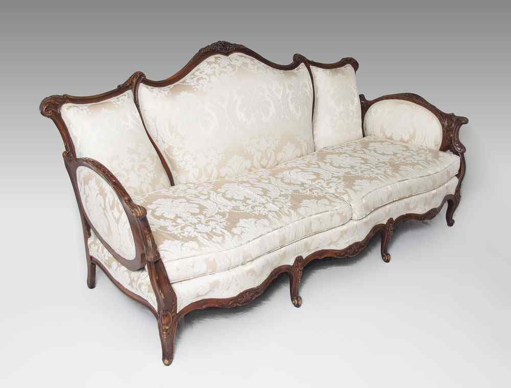 Appraisal: FRENCH STYLE CARVED SOFA Carved and shaped top rail with