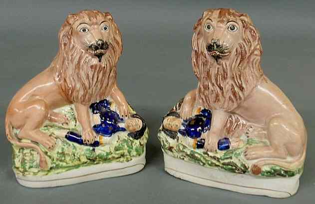 Appraisal: Rare pair of th c Staffordshire lions above a defeated