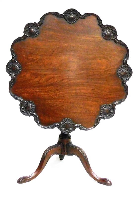 Appraisal: Chippendale tea table with elaborately carved shell edge tilt top