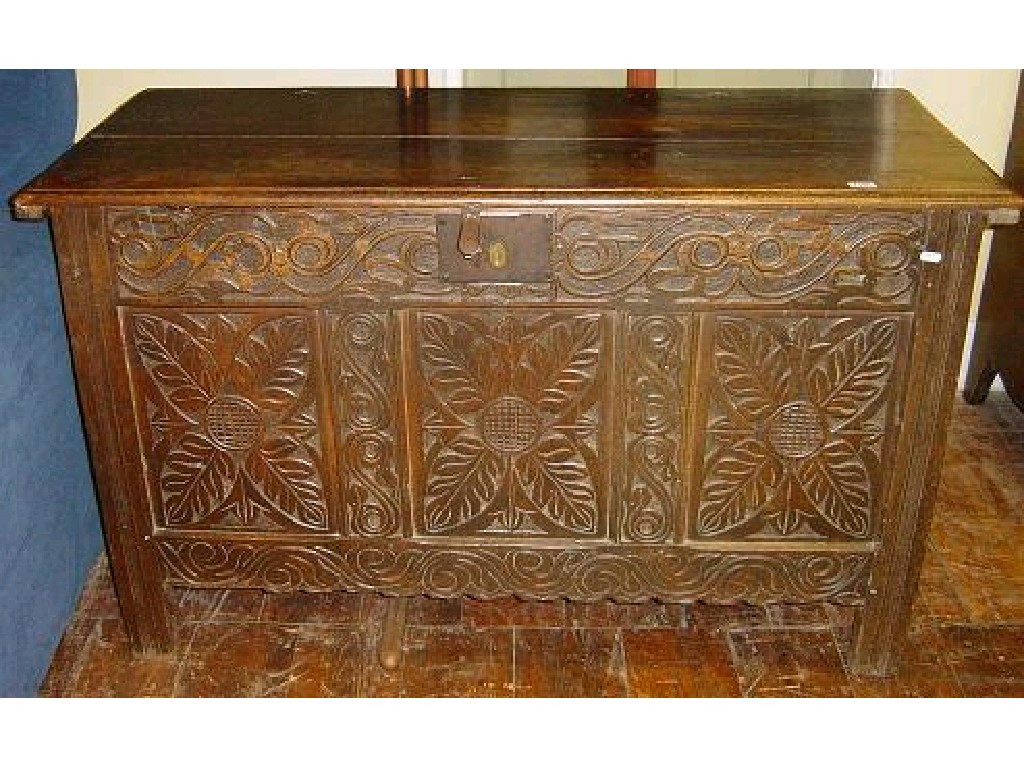 Appraisal: A Georgian oak coffer with panelled frame and later carved