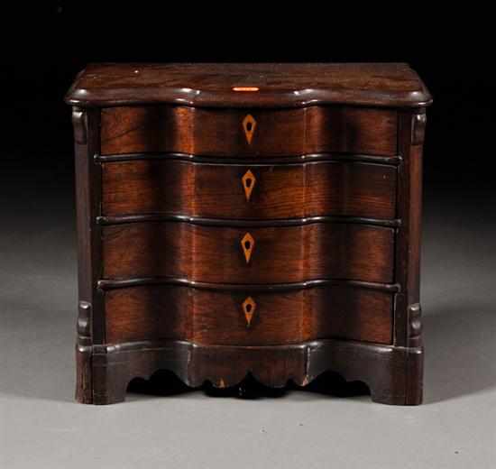 Appraisal: Rococo Revival rosewood serpentine miniature chest of drawers mid th