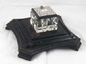 Appraisal: A square cut glass inkwell with silver mounted swivel cover