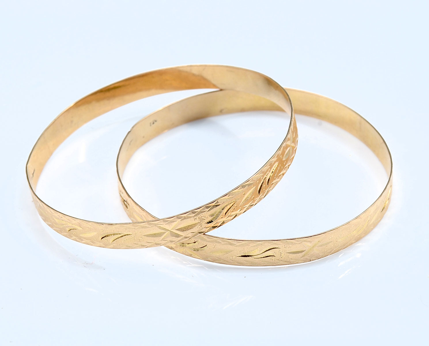 Appraisal: PAIR OF ETCHED K GOLD BANGLES Etched yellow gold bangles