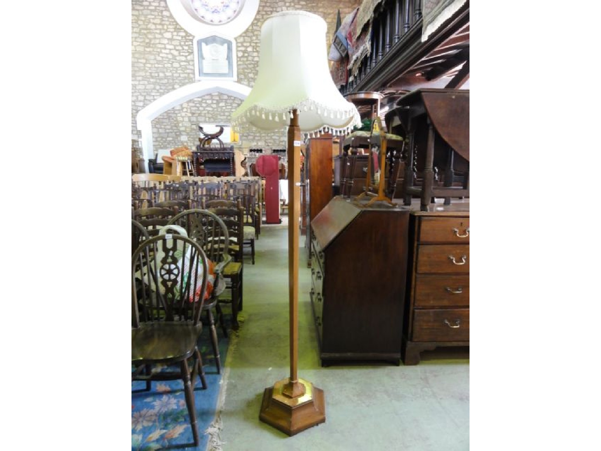 Appraisal: A walnut veneered standard lamp with hexagonal tapered column and