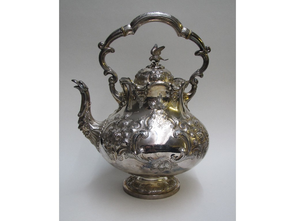 Appraisal: A Victorian silver tea kettle embossed with flowers and foliage