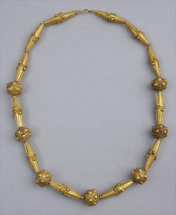 Appraisal: PERSIAN GOLD NECKLACE Strand of large biconical beads interspersed with