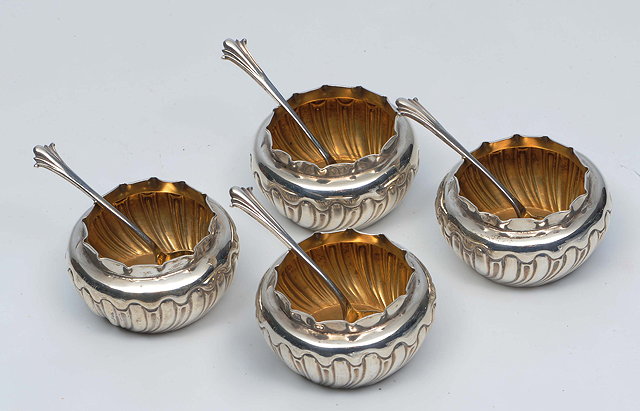 Appraisal: A SET OF FOUR SILVER PARCEL GILT SALTS together with