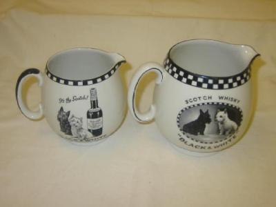 Appraisal: Two black and white Scotch jugs by Shelley with chequered