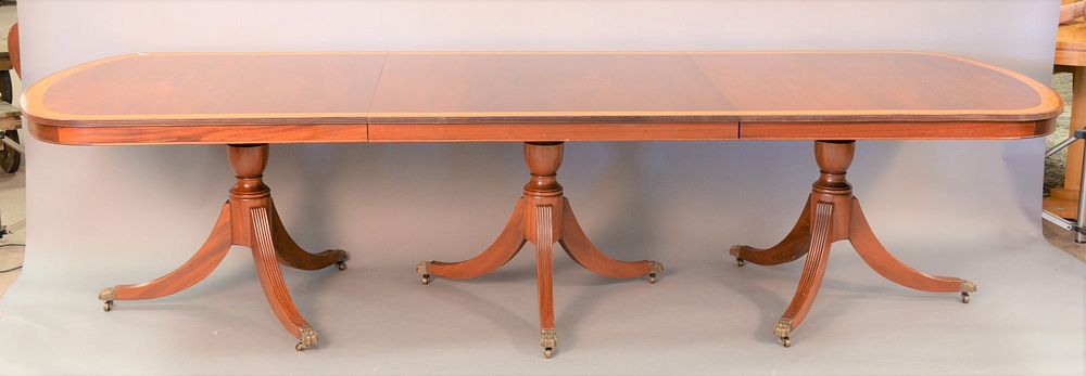 Appraisal: Custom mahogany triple pedestal dining table with two extra leaves