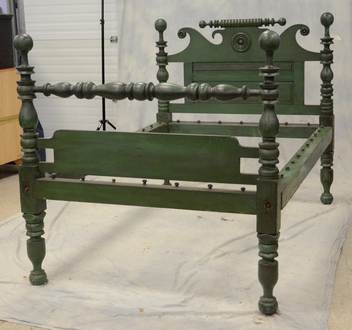 Appraisal: Turned and carved cannonball post green painted rope bed with