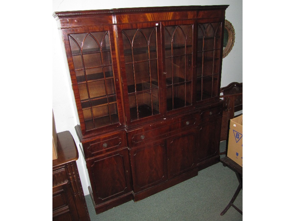 Appraisal: Mahogany breakfront bookcase on cupboard base