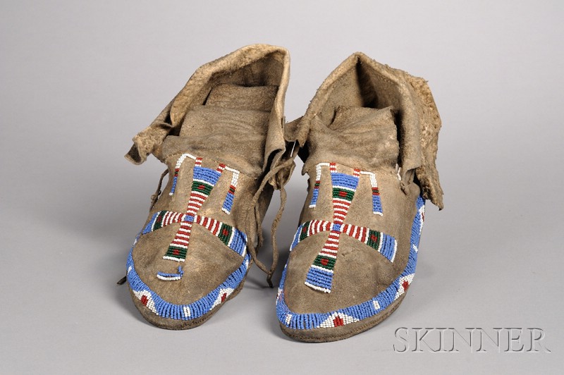 Appraisal: Arapaho Beaded Moccasins and a Navajo Rug moccasins beaded hide