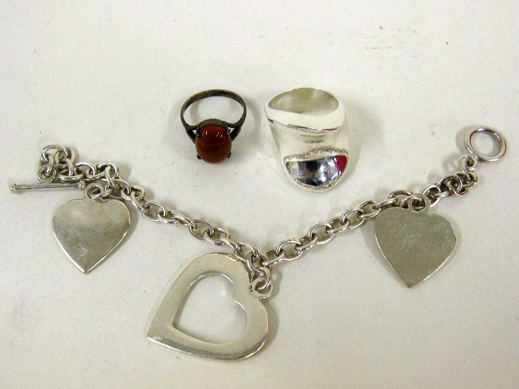 Appraisal: Lot comprising a silver charm bracelet and two silver dress