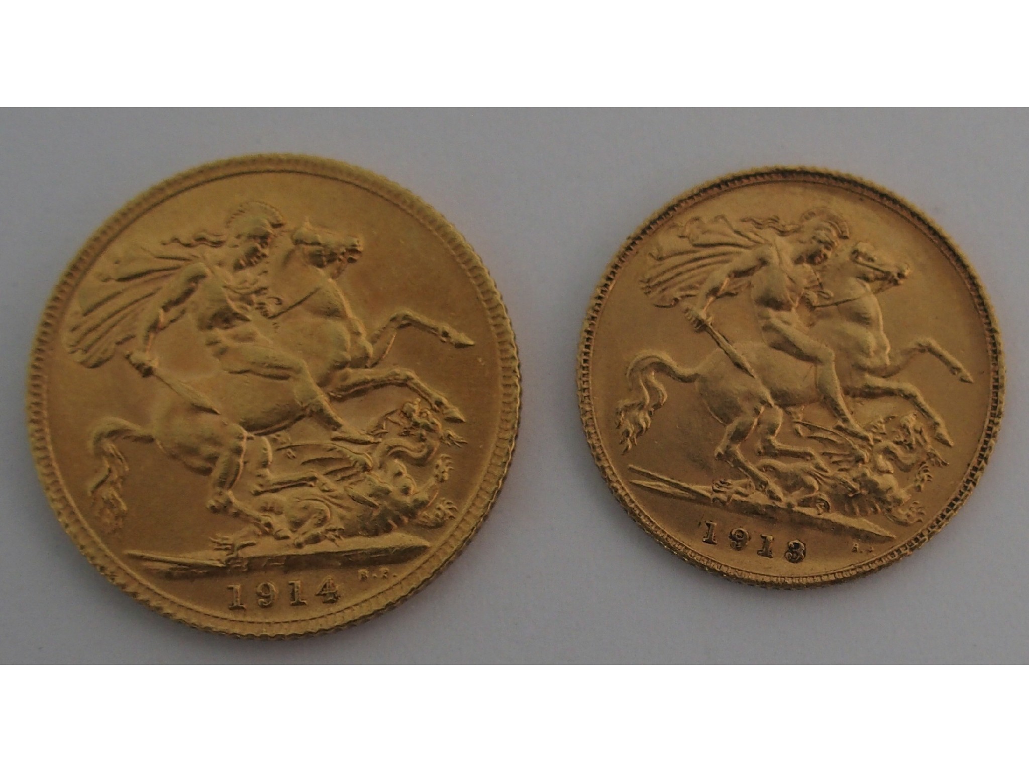 Appraisal: George V gold Sovereign EF George V gold half Sovereign