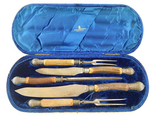 Appraisal: A boxed set of stag antler handled carving utensils by