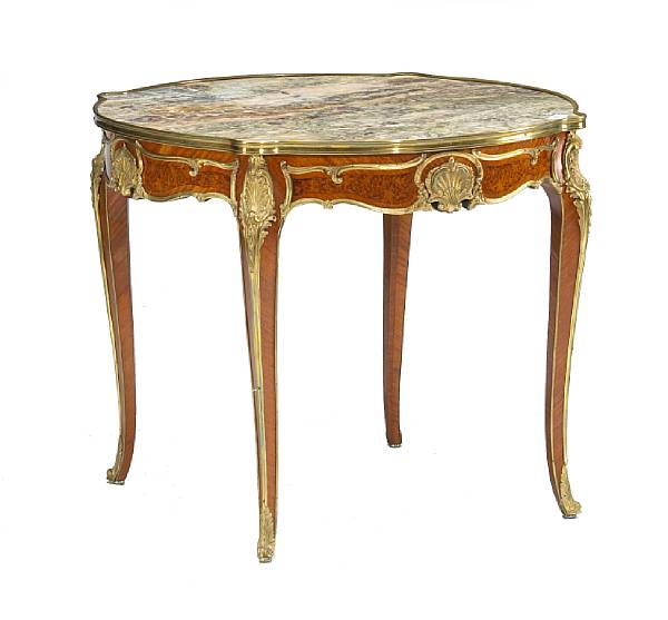 Appraisal: The variegated marble gilt banded serpentine top over a recessed