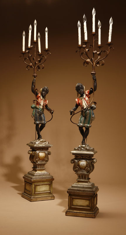 Appraisal: A pair of Italian Rococo style polychrome-decorated blackamoor torchieres A