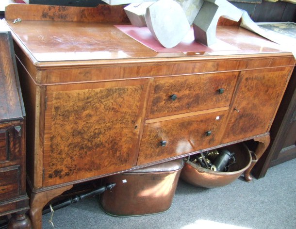 Appraisal: A th century walnut sideboard with a pair of central