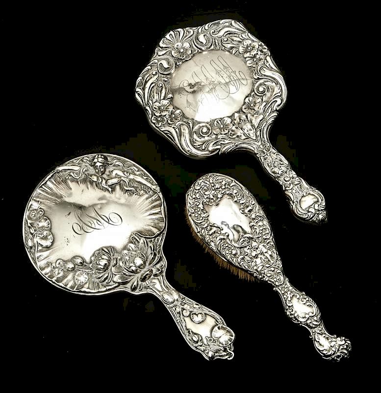 Appraisal: Sterling repousse hand mirrors and brush Sterling repousse hand mirrors